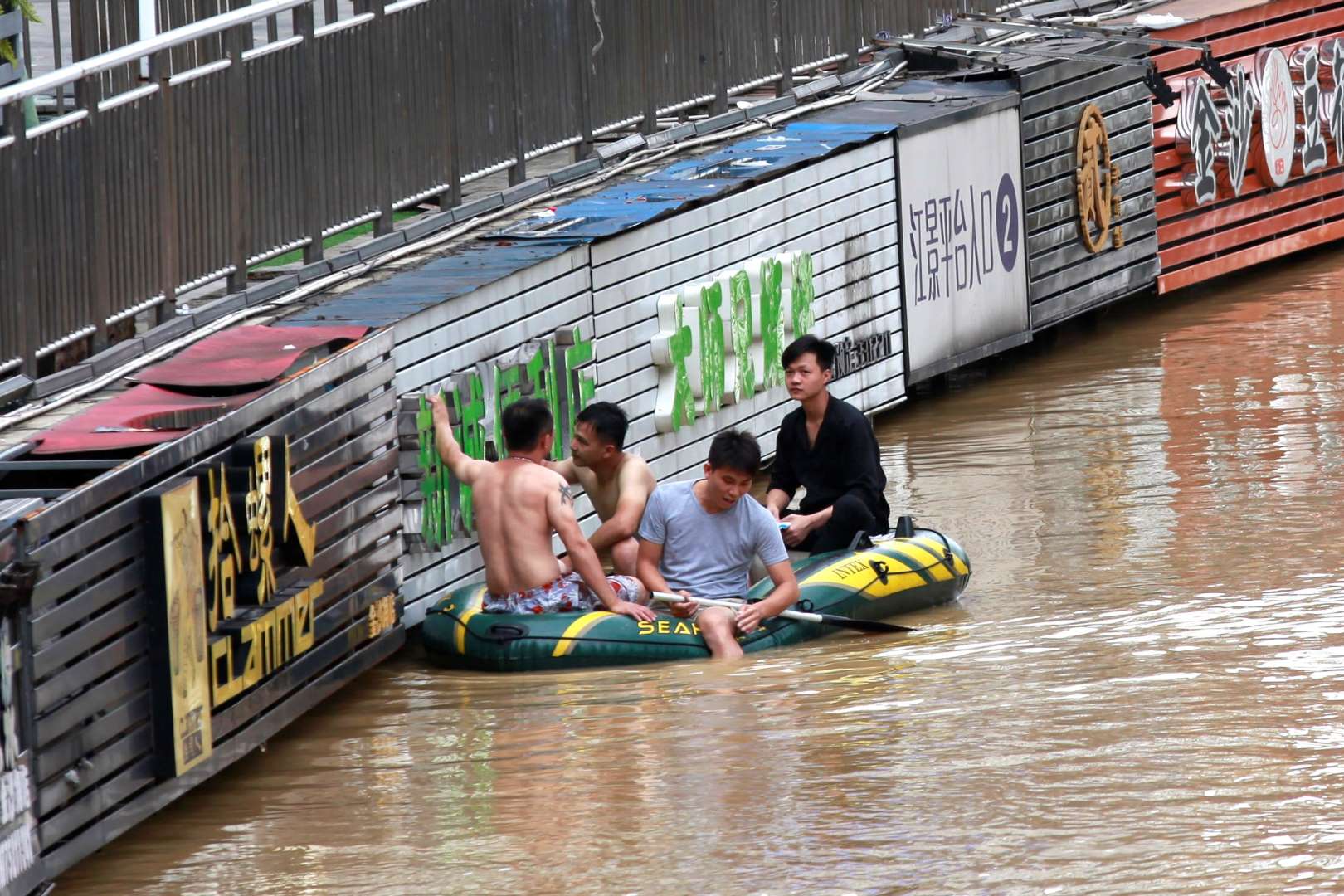 Povodně v Číně a muži na člunu
